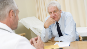 Man talking to his doctory about seeing an endovascular specialist