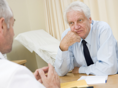 Man talking to his doctory about seeing an endovascular specialist